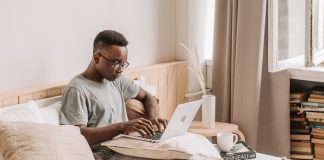 Man on Laptop in Bed