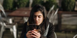 Woman Holding a Phone and Credit Card