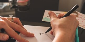 Person Writing a Note