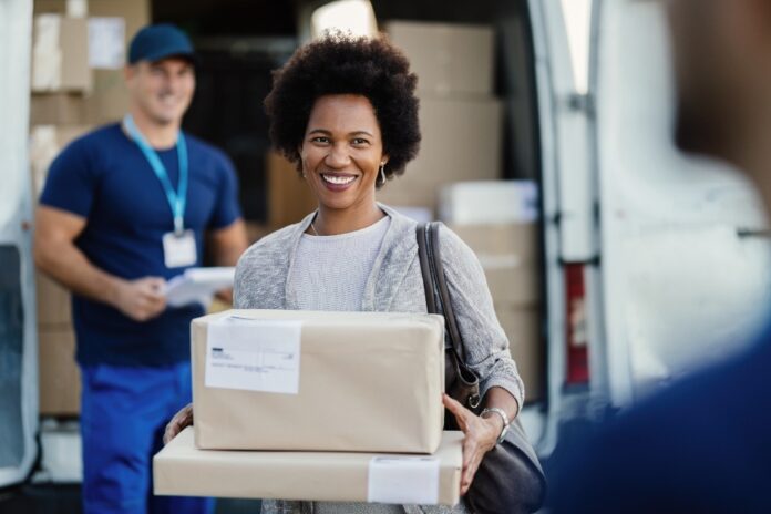 woman-receiving-package-from-delivery-person-at-va-2026-01-06-10-28-06-utc Shipping-Service