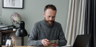 Man holding money from loans