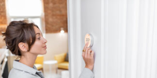 Person with smart thermostat