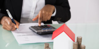 Business Person calculating finances to buy a home