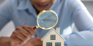 Business Person inspecting house for radon