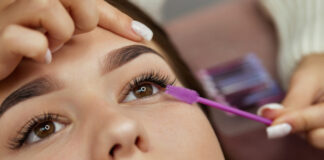 Business Person Adding Eyelash Extensions on a Client