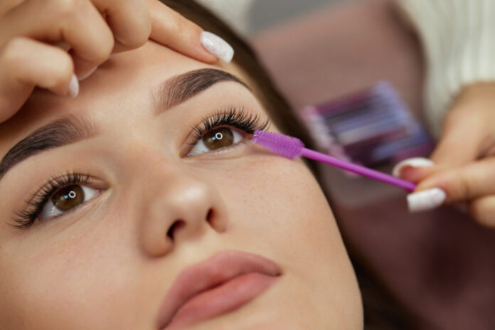 Business Person Adding Eyelash Extensions on a Client