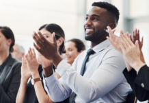 Professionals applauding enthusiastically at prestigious business awards ceremony for the Company