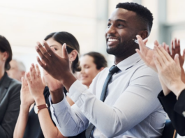 Professionals applauding enthusiastically at prestigious business awards ceremony for the Company