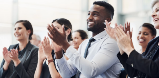 Professionals applauding enthusiastically at prestigious business awards ceremony for the Company