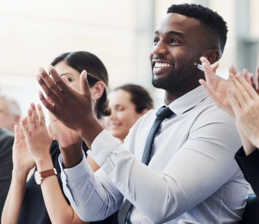 Professionals applauding enthusiastically at prestigious business awards ceremony for the Company