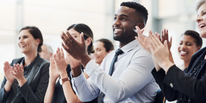 Professionals applauding enthusiastically at prestigious business awards ceremony for the Company