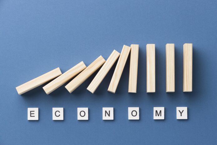 top-view-wooden-pieces-arrangement-with-economy-word Slice-of -the-Economy