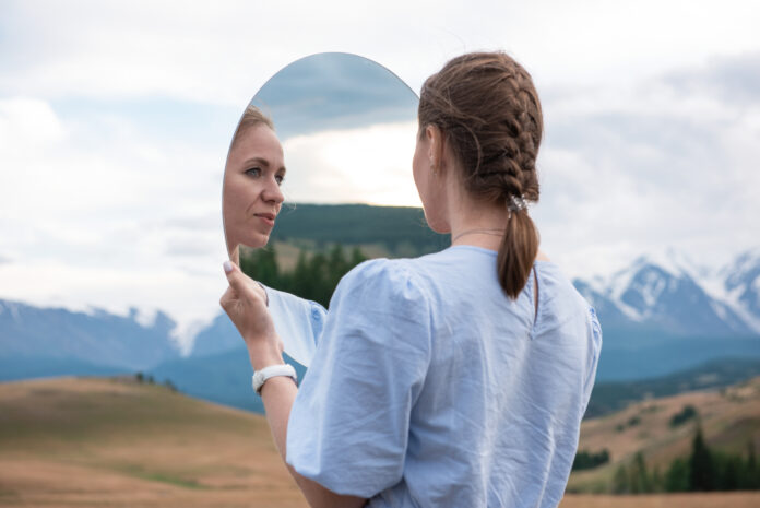 Woman in blue dress in summer Altai mountains who- do- you- see- first -kaplan