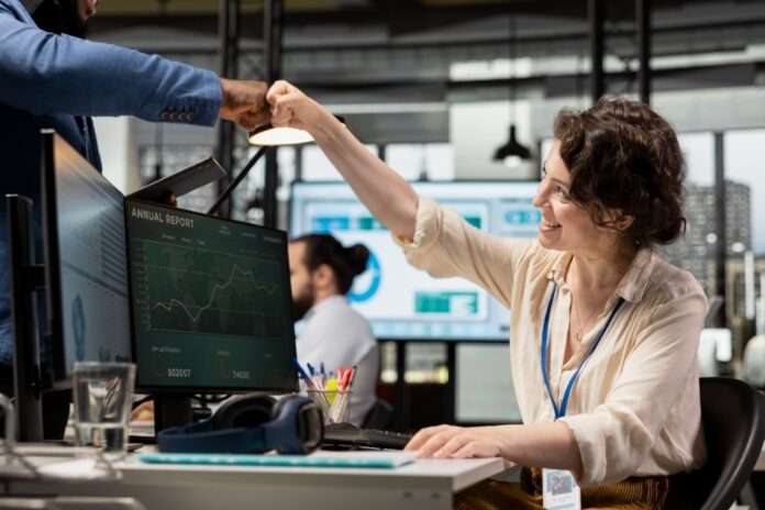 multiethnic-colleagues-greeting-each-other-with-fist-bump-corporate-space-office-friends-saluting Outsourcing for small business owners
