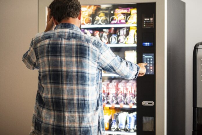 man-using-vending-machine-in-modern-office-2026-01-08-06-59-22-utc Vending Machines With Credit Card Reader solutions