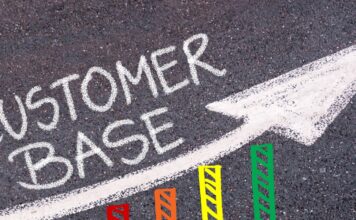 How Your Company Can Increase Its Number of Clients A bar graph shows an upward trend and features the words "Customer Base" above it. It also has an upward-pointing arrow.