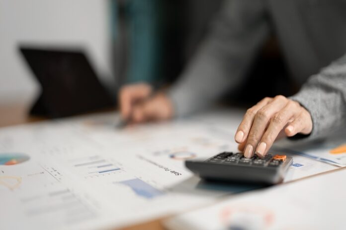 business-professional-analyzing-data-with-calculat-2026-01-07-02-14-47-utc How MSPs Record Deferred Revenue