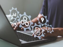 A person uses a laptop with digital icons representing automation, workflows, and business system management tools.
