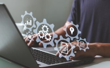 A person uses a laptop with digital icons representing automation, workflows, and business system management tools.