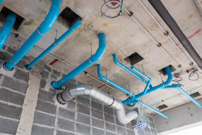ceiling-with-exposed-piping-and-ductwork-installat-2026-03-20-02-15-29-utc-1000x667 What an HVAC Drain Line Does