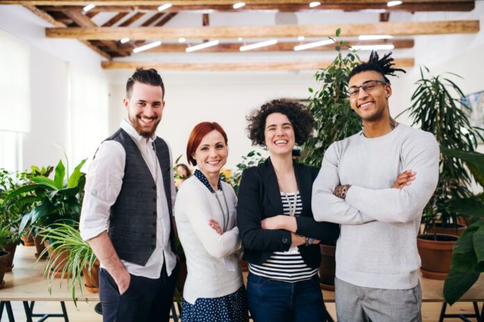 group-of-young-businesspeople-standing-in-office-2026-01-05-06-18-36-utc-1000x667 Turn Content Into a More Sustainable Creator Business