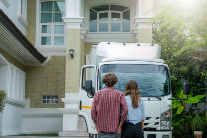 couple-stands-before-moving-truck-outside-house-2026-03-16-22-54-01-utc-1000x667 Wellington Moves Need a Parking Plan